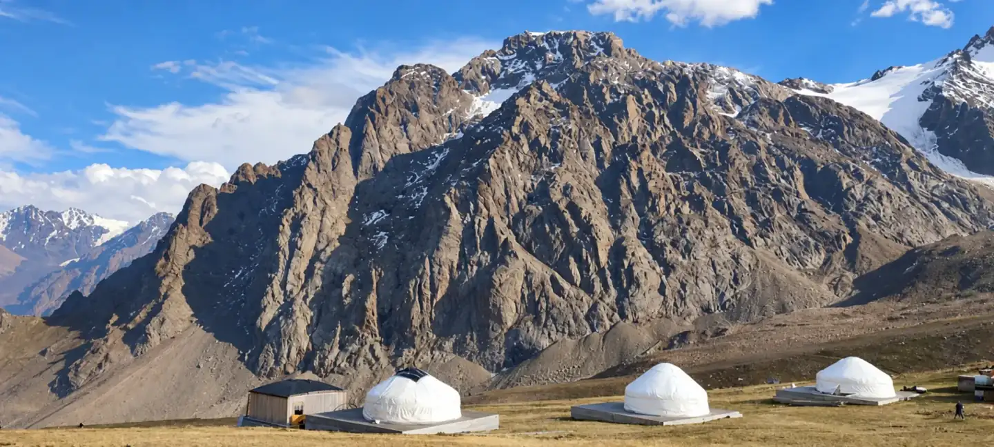 Rocky mountain landscape with yurts