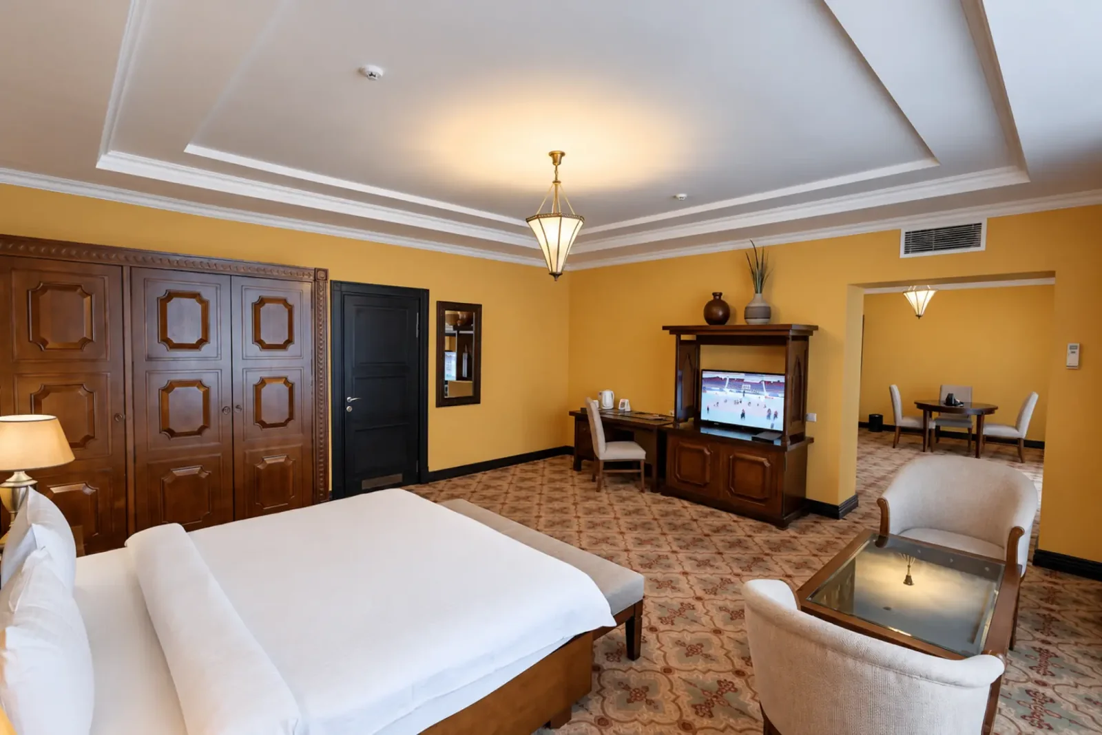 Room interior with a double bed and armchairs at Samal