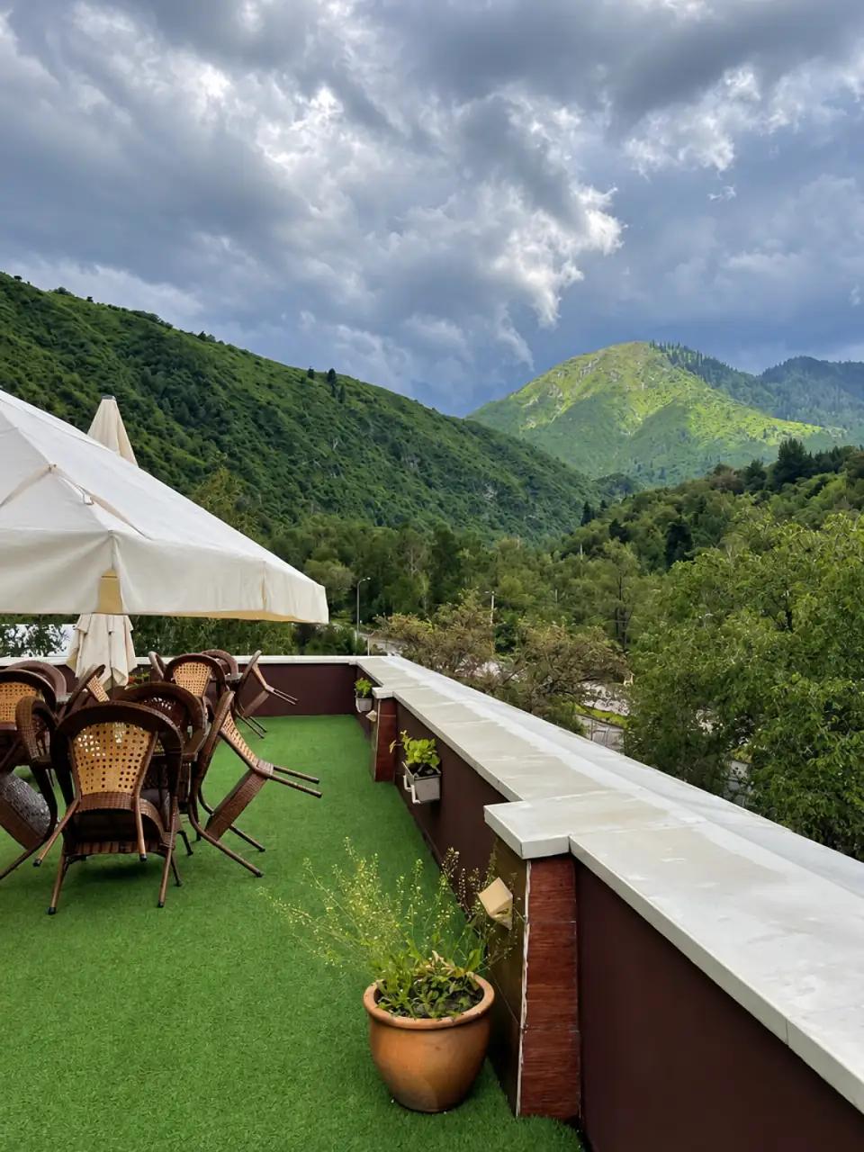 Resort terrace overlooking green mountain slopes